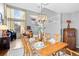 Light-filled dining room with tall ceilings and table set for dinner at 6802 Poppy Ct, Arvada, CO 80007