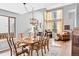 Dining room with natural light and wood table set for six at 6802 Poppy Ct, Arvada, CO 80007
