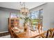 Dining room with a large window showcasing an outdoor view and a chandelier over the dining table at 6802 Poppy Ct, Arvada, CO 80007