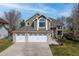 Beautiful two-story home with a three-car garage, manicured lawn, and brick accents at 6802 Poppy Ct, Arvada, CO 80007