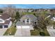 Beautiful home showcasing a manicured front yard, a three car garage and large windows at 6802 Poppy Ct, Arvada, CO 80007