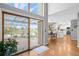Open floor plan with a sliding glass door to the patio and views of a pond and the kitchen area at 6802 Poppy Ct, Arvada, CO 80007