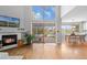 Living room with fireplace and a large window providing abundant natural light and a view at 6802 Poppy Ct, Arvada, CO 80007