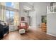Bright living room with tall ceilings, large windows, hardwood floors, and neutral paint at 6802 Poppy Ct, Arvada, CO 80007