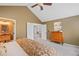Spacious main bedroom featuring vaulted ceilings, neutral carpeting, and ensuite bathroom access at 6802 Poppy Ct, Arvada, CO 80007