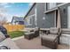 Comfortable backyard patio with wicker furniture and a view of the well-manicured lawn at 9208 W 100Th Pl, Broomfield, CO 80021