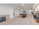 Expansive basement area with a pool table, seating area, and neutral carpeting at 9208 W 100Th Pl, Broomfield, CO 80021