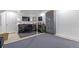 Finished basement featuring a work area with gray metal storage lockers and comfortable seating at 9208 W 100Th Pl, Broomfield, CO 80021