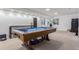 Spacious finished basement featuring a pool table, neutral carpet, and ample lighting at 9208 W 100Th Pl, Broomfield, CO 80021