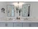 Bathroom featuring double vanity, modern fixtures, a glass shower enclosure, and decorative succulent arrangement at 9208 W 100Th Pl, Broomfield, CO 80021