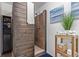 Rustic bathroom with wood-paneled shower and dark wood storage cabinet at 9208 W 100Th Pl, Broomfield, CO 80021