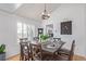Cozy dining room featuring modern light fixture, and an adjacent kitchen with white cabinets at 9208 W 100Th Pl, Broomfield, CO 80021