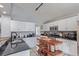 Modern kitchen with white cabinets, black countertops, stainless steel appliances, and central island at 9208 W 100Th Pl, Broomfield, CO 80021