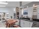 Open kitchen with black countertops, an island, and view to the Gathering room at 9208 W 100Th Pl, Broomfield, CO 80021