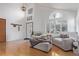 Inviting living room with vaulted ceilings, large windows, and stylish furnishings at 9208 W 100Th Pl, Broomfield, CO 80021