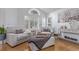 Bright living room featuring modern furnishings, large windows with shutters, and hardwood floors at 9208 W 100Th Pl, Broomfield, CO 80021