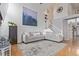Spacious living room featuring a large sectional sofa, hardwood floors, and a staircase at 9208 W 100Th Pl, Broomfield, CO 80021