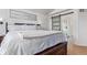 Bright main bedroom with a walk-in glass shower behind a sliding barn door and hardwood floors at 9208 W 100Th Pl, Broomfield, CO 80021