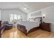 Spacious main bedroom with hardwood floors, natural light, ceiling fan, and vaulted ceiling at 9208 W 100Th Pl, Broomfield, CO 80021