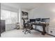 Bright office featuring a dark wood desk, neutral walls, a window, and neutral carpet at 9208 W 100Th Pl, Broomfield, CO 80021