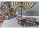 Outdoor patio features a table, chairs, and a striped umbrella, providing a relaxing space at 9208 W 100Th Pl, Broomfield, CO 80021