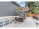 Cozy outdoor patio with table, chairs, and a striped umbrella, perfect for relaxing at 9208 W 100Th Pl, Broomfield, CO 80021