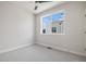 Bright bedroom featuring a ceiling fan, a large window, and neutral walls and carpet at 888 S Valentia St # 104, Denver, CO 80247