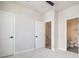 Bright bedroom with two doors, neutral paint, carpet and views of the ensuite bathroom at 888 S Valentia St # 104, Denver, CO 80247