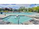 A spacious community pool area offers plenty of lounge chairs and umbrellas for residents to enjoy at 888 S Valentia St # 104, Denver, CO 80247