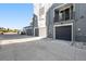 Townhouse garages with neutral doors and decorative rock near the driveway for enhanced curb appeal at 888 S Valentia St # 104, Denver, CO 80247