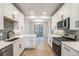 Bright kitchen with stainless steel appliances, white cabinets and a dining area off the side at 888 S Valentia St # 104, Denver, CO 80247