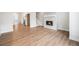 Cozy living room with wood floors, an electric fireplace and an open floor plan at 888 S Valentia St # 104, Denver, CO 80247