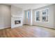 Bright living room with hardwood floors, a modern fireplace, and large windows at 888 S Valentia St # 104, Denver, CO 80247