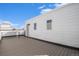 Spacious rooftop deck with wood-look flooring and white siding at 888 S Valentia St # 104, Denver, CO 80247