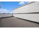 Spacious rooftop deck with wood-look flooring and white siding at 888 S Valentia St # 104, Denver, CO 80247