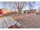 Spacious backyard featuring mature trees, a picnic table, and a storage shed at 6167 Newland St, Arvada, CO 80003