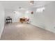 Unfinished basement with carpet flooring, lighting, and a small window at 6167 Newland St, Arvada, CO 80003