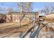 Charming brick home featuring a covered parking area and a well-maintained front yard at 6167 Newland St, Arvada, CO 80003