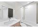 Bright bathroom featuring a shower-over-tub, modern vanity, and stylish neutral and gold accent tiles at 1836 Grove St # 105, Denver, CO 80204