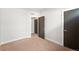 Bedroom with neutral carpet and a view of the hallway through an open door at 1836 Grove St # 105, Denver, CO 80204
