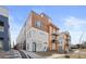 Stylish modern townhome featuring wood and metal accents, with a convenient walkway and community mailbox access at 1836 Grove St # 105, Denver, CO 80204