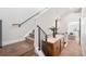 Hallway with carpeted stairs, custom banister, and a glimpse into the main bedroom at 1836 Grove St # 105, Denver, CO 80204