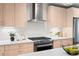 Well-lit kitchen with modern appliances, white countertops, and light wood cabinetry at 1836 Grove St # 105, Denver, CO 80204