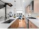 Modern kitchen with a large island, stainless appliances, and open living area at 1836 Grove St # 105, Denver, CO 80204