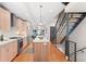 Modern kitchen with stainless appliances, and an island, adjacent to staircase at 1836 Grove St # 105, Denver, CO 80204
