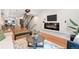 Open-concept living space with kitchen view, sleek fireplace, and modern design elements at 1836 Grove St # 105, Denver, CO 80204