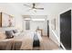 Bright main bedroom with a ceiling fan, plush bedding, and ample natural light at 1836 Grove St # 105, Denver, CO 80204