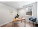 Cozy office space with a wooden desk, neutral walls, and a window providing natural light, perfect for a home workspace at 1836 Grove St # 105, Denver, CO 80204