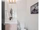 Neat powder room with a contemporary vanity, modern fixtures, and a sleek framed mirror above the sink at 1836 Grove St # 105, Denver, CO 80204