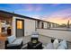 Comfortable rooftop deck featuring outdoor seating, perfect for relaxation and enjoying city views with sunset skies at 1836 Grove St # 105, Denver, CO 80204